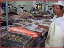 Mercado de Mariscos merchant with his product